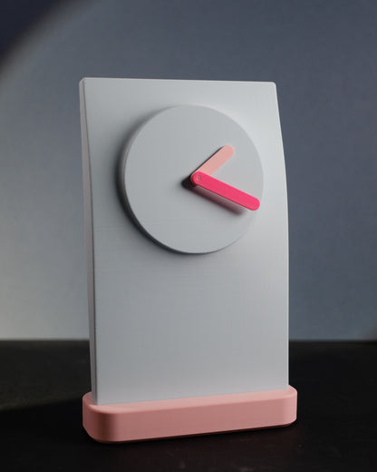 Simplify Wall Clock photographed straight on to show the clock face and color contrast.