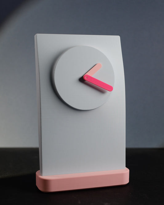 Simplify Wall Clock photographed straight on to show the clock face and color contrast.