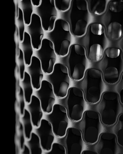 Chain Pendant Light detail showing the open structure, texture, and warm light effect.