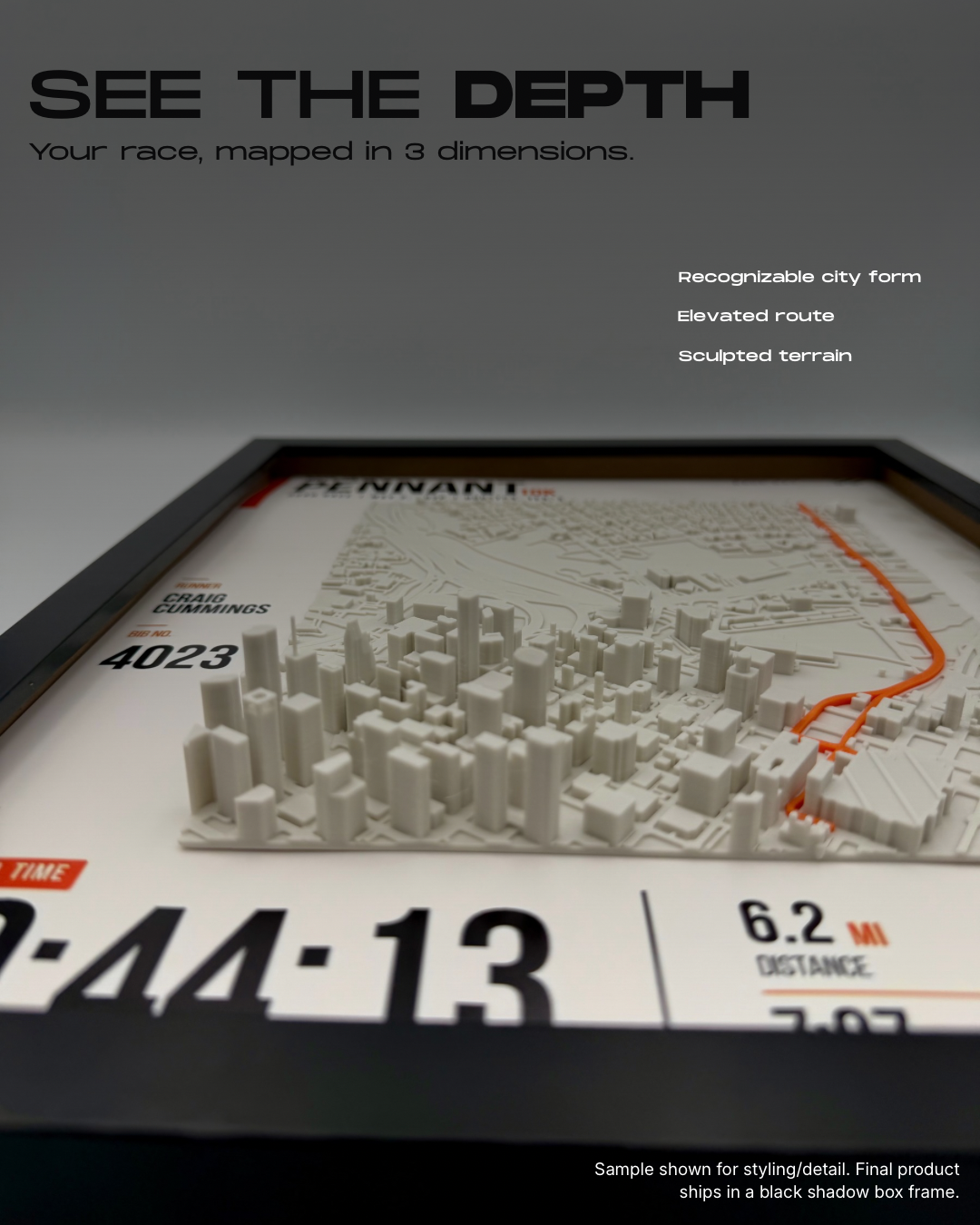 Low-angle view of the raised city, elevated orange route and race poster inside a black frame.