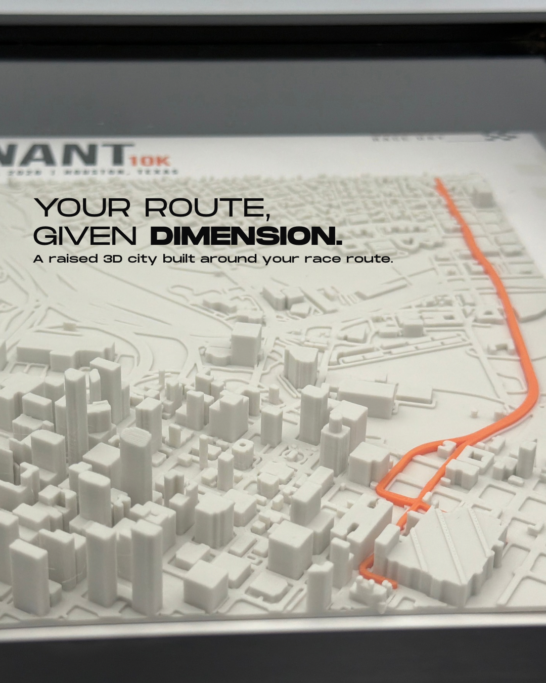 Close-up of raised light-colored city buildings and an orange race route in a Trace frame.