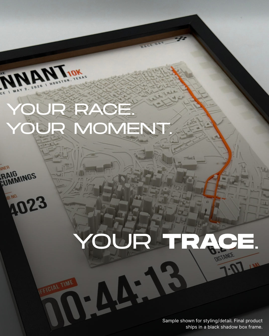 Framed Gallery Trace sample with raised city buildings, orange route and personalized race poster.